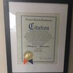 A closeup look at the Citation Certificate Framed on the wall